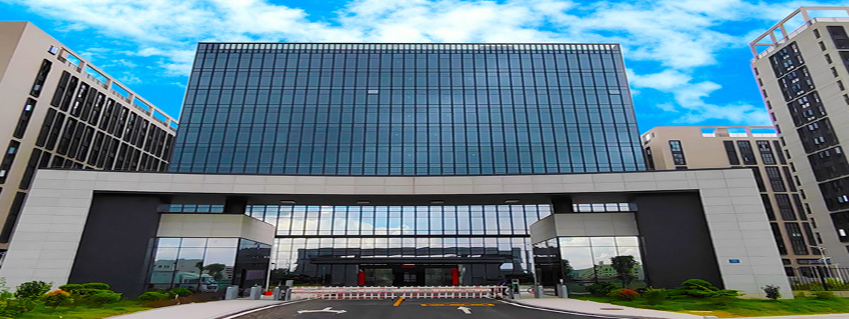 Exterior of a building complex with a glass facade and entrance, provided by the company